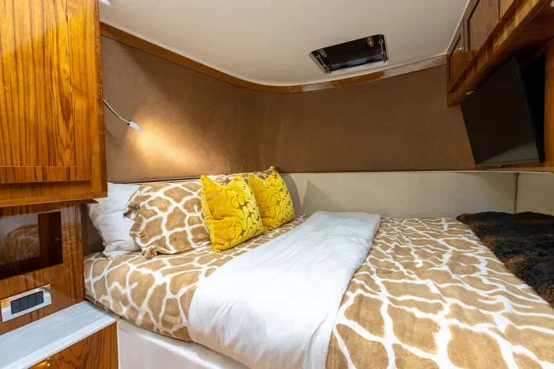 Slide: The Image of Luxurious cabin interior of 2023 HCB 65 Estrella with patterned bedding and wooden accents. - 30