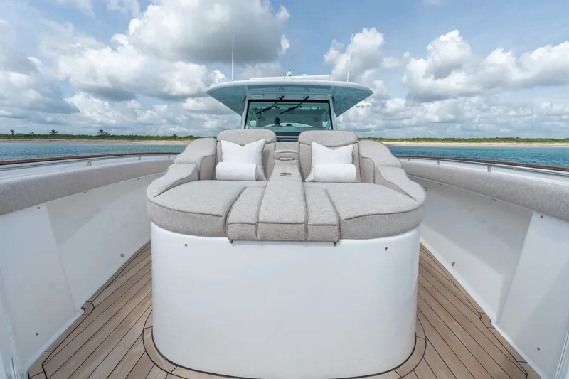 Slide: The Image of Luxurious 2023 HCB 65 Estrella yacht with plush seating on deck, under a cloudy sky. - 22