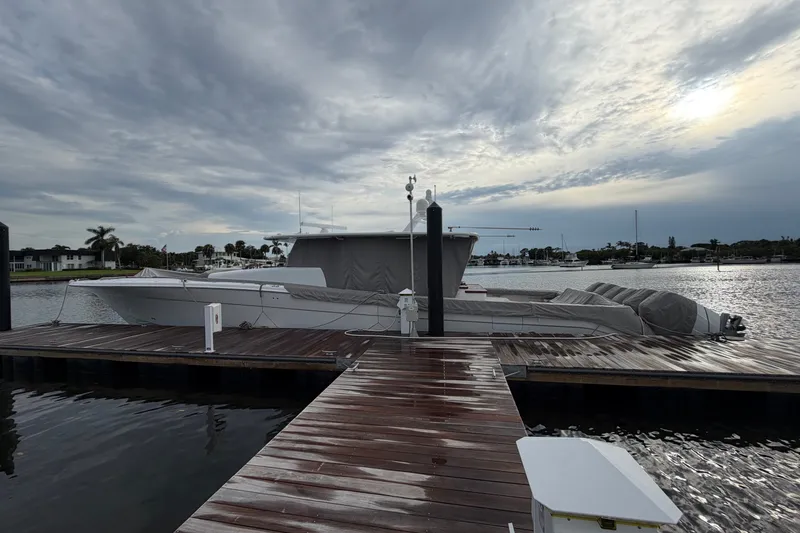 Slide: The Image of 2023 HCB 65 Estrella yacht docked under cloudy skies at a marina. - 58