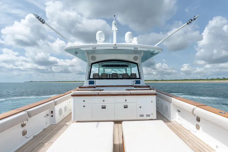 Slide: The Image of 2023 HCB 65 Estrella yacht on open water, showcasing spacious deck and luxurious design. - 47