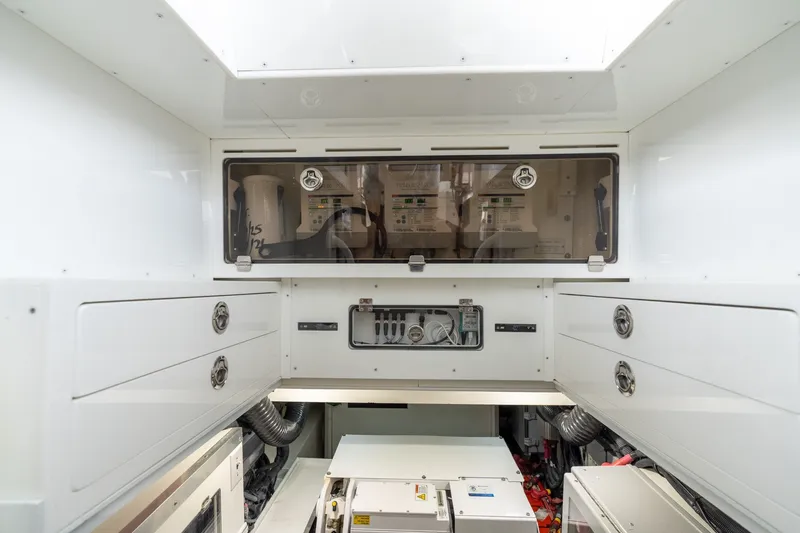 Slide: The Image of Engine room of 2023 HCB 65 Estrella, featuring organized storage and control panels. - 57