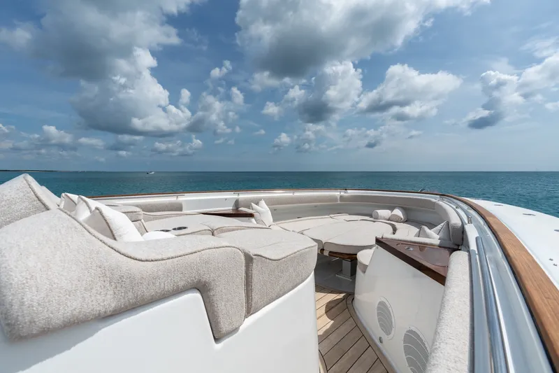 Slide: The Image of Luxurious 2023 HCB 65 Estrella yacht with elegant seating, ocean view, and cloudy sky. - 24