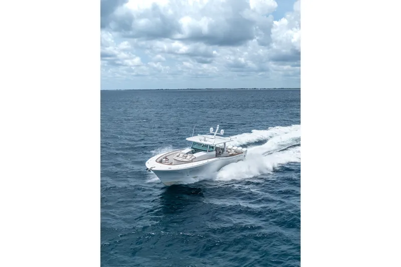 Slide: The Image of 2023 HCB 65 Estrella cruising on open ocean under cloudy sky. - 13