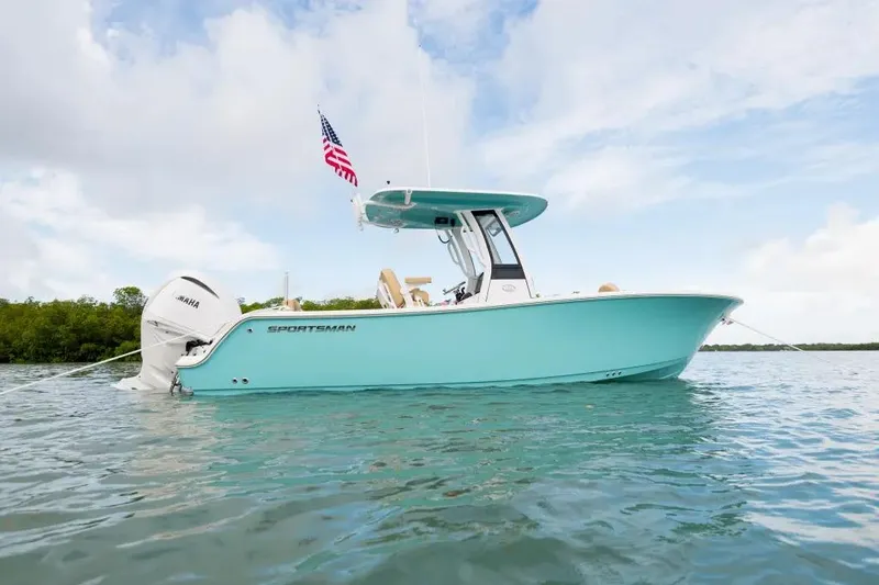 Slide: The Image of 2027 Sportsman Heritage 231 Center Console boat on water, featuring sleek design and Yamaha engine. - 9