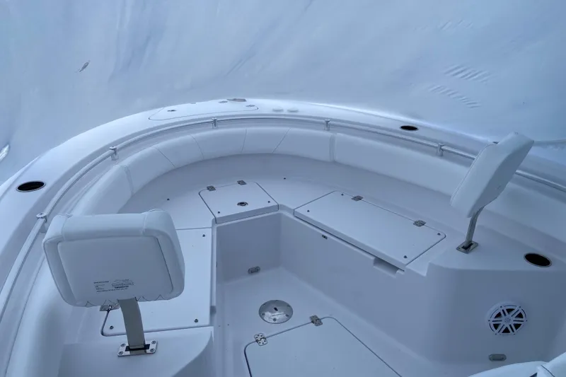 Slide: The Image of 2027 Sportsman Heritage 231 Center Console boat interior with white seating and storage compartments. - 6