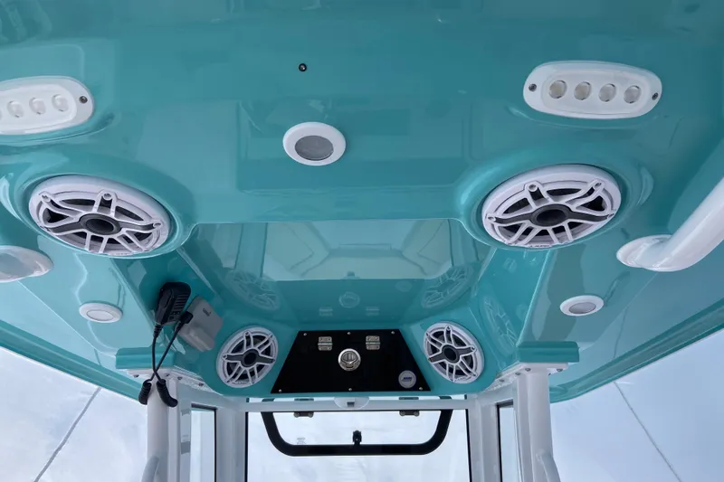 Slide: The Image of 2027 Sportsman Heritage 231 Center Console boat interior with speakers and controls. - 5