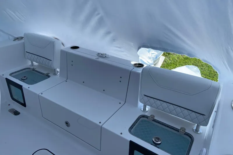 Slide: The Image of 2027 Sportsman Heritage 231 Center Console boat interior with seating and storage compartments. - 2