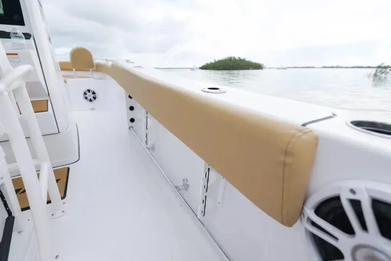 Slide: The Image of 2027 Sportsman Heritage 231 Center Console boat interior with tan seating and ocean view. - 8