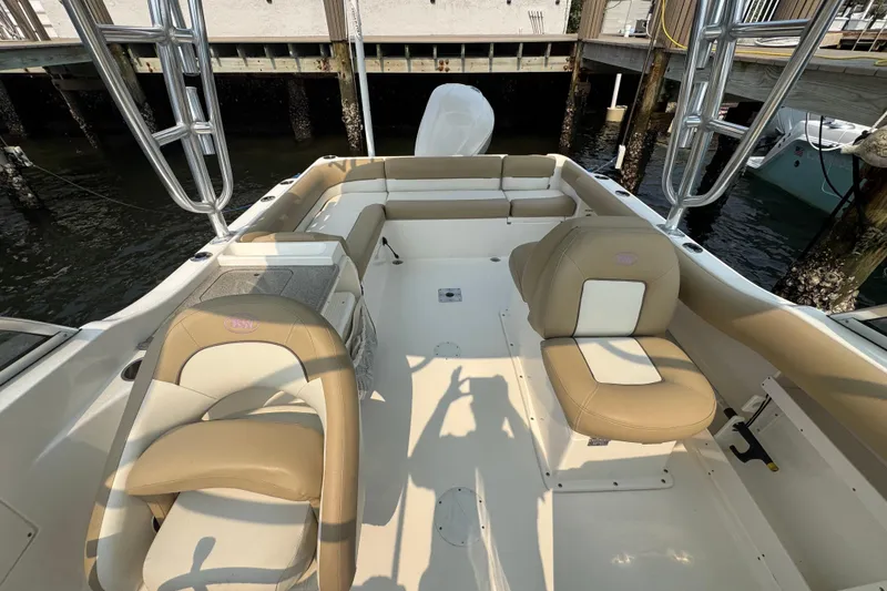 Slide: The Image of 2019 Key West 239 DFS boat interior with beige seating and dockside view. - 2