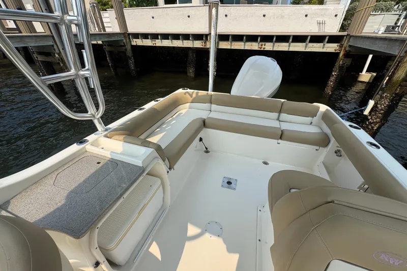 Slide: The Image of The image shows the cockpit of a 2019 Key West 239 DFS boat with beige seating. - 3