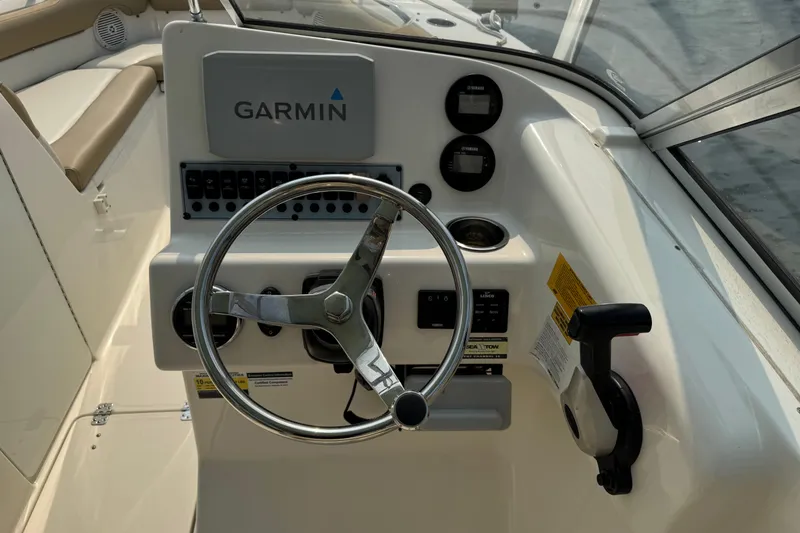 Slide: The Image of 2019 Key West 239 DFS boat dashboard with Garmin navigation system and steering wheel. - 6