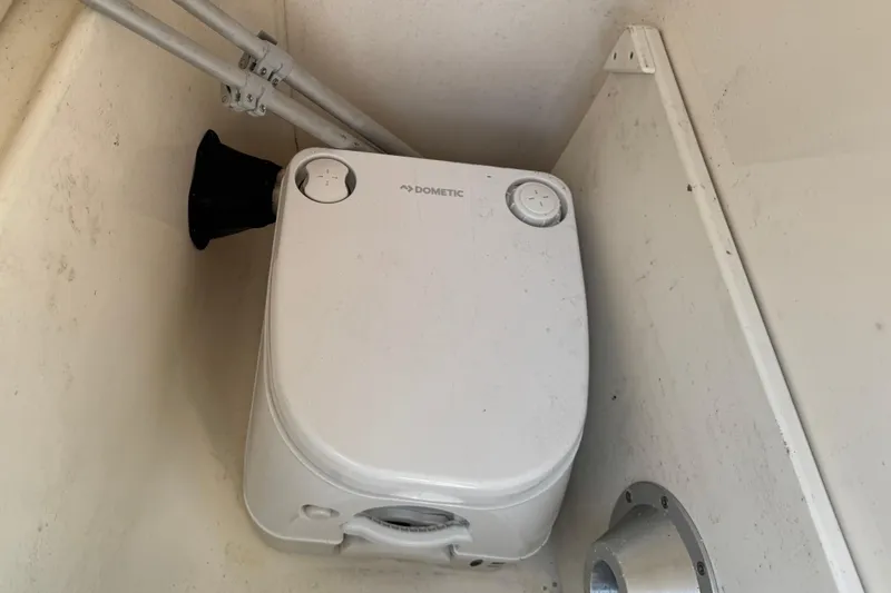 Slide: The Image of A portable Dometic toilet system inside a boat. - 11