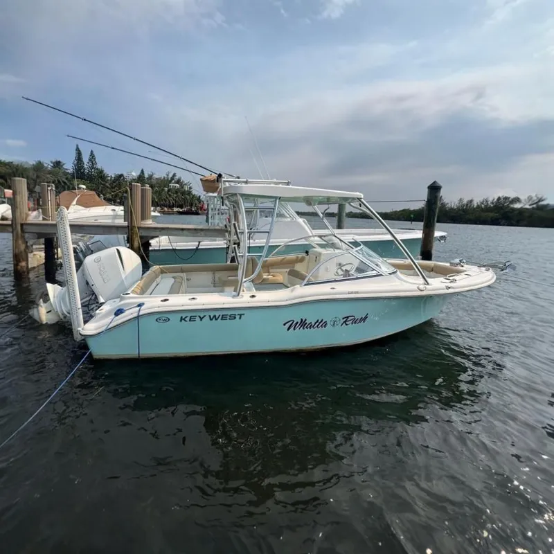 The Image of A 2019 Key West 239 DFS boat docked. It features a white exterior and an open cockpit. - 0