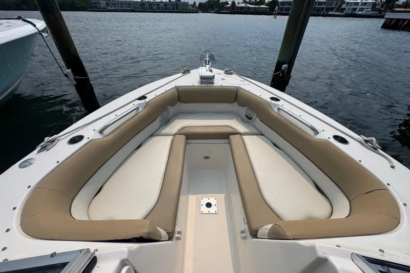 Slide: The Image of 2019 Key West 239 DFS boat with beige seating, docked on calm water. - 9