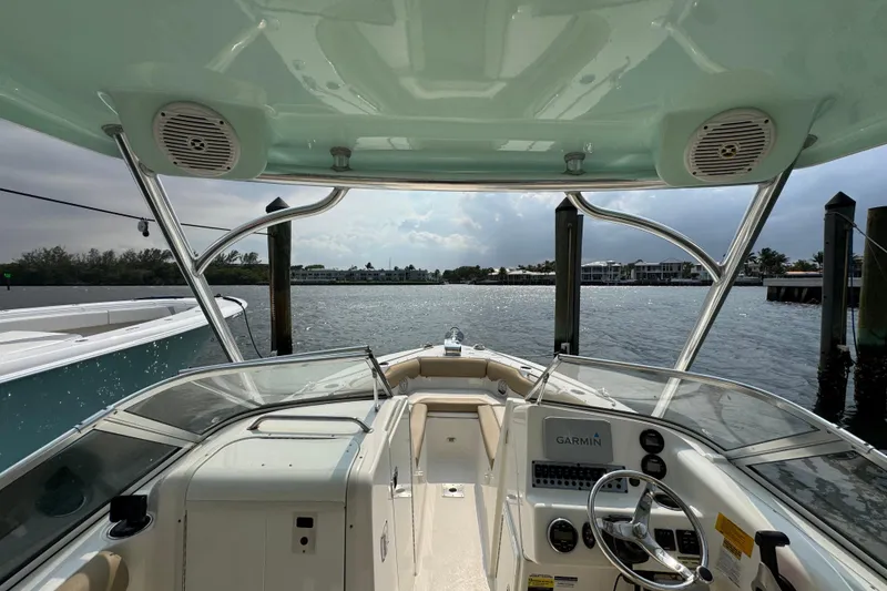 Slide: The Image of 2019 Key West 239 DFS boat interior with Garmin navigation, docked by waterfront homes. - 8