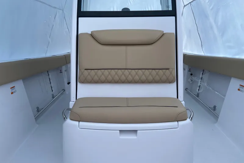 Slide: The Image of 2027 Sportsman Heritage 261 Center Console boat interior with tan cushioned seating. - 9