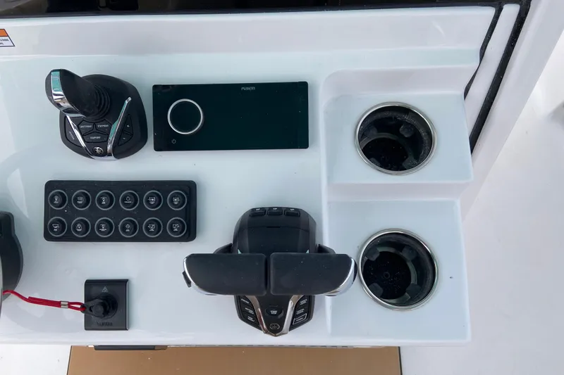 Slide: The Image of Control panel of 2027 Sportsman Heritage 261 Center Console with joystick and cup holders. - 6