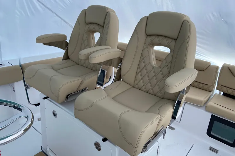 Slide: The Image of Luxurious seating on 2027 Sportsman Heritage 261 Center Console boat, featuring beige upholstery. - 4
