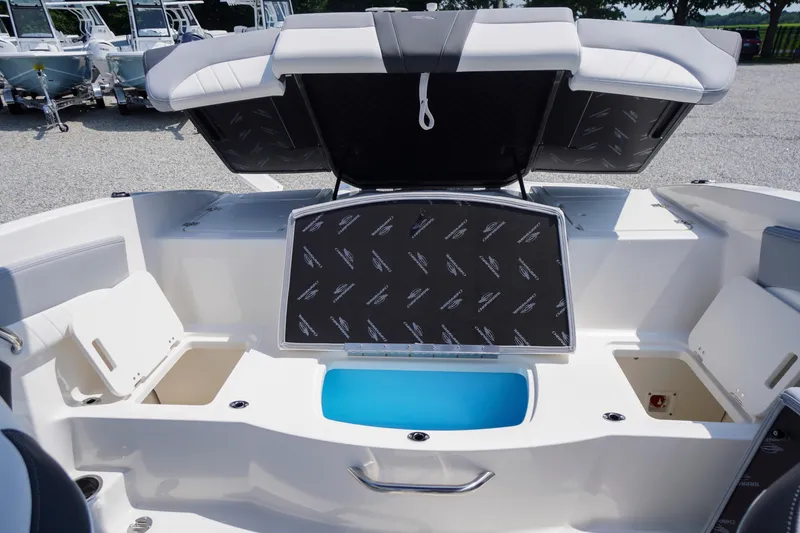 Slide: The Image of 2026 Chaparral 21 SSi OB boat interior with open storage compartments and seating. - 33
