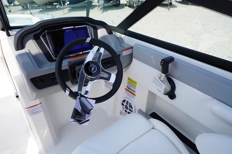 Slide: The Image of 2026 Chaparral 21 SSi OB boat cockpit with steering wheel and control panel. - 14