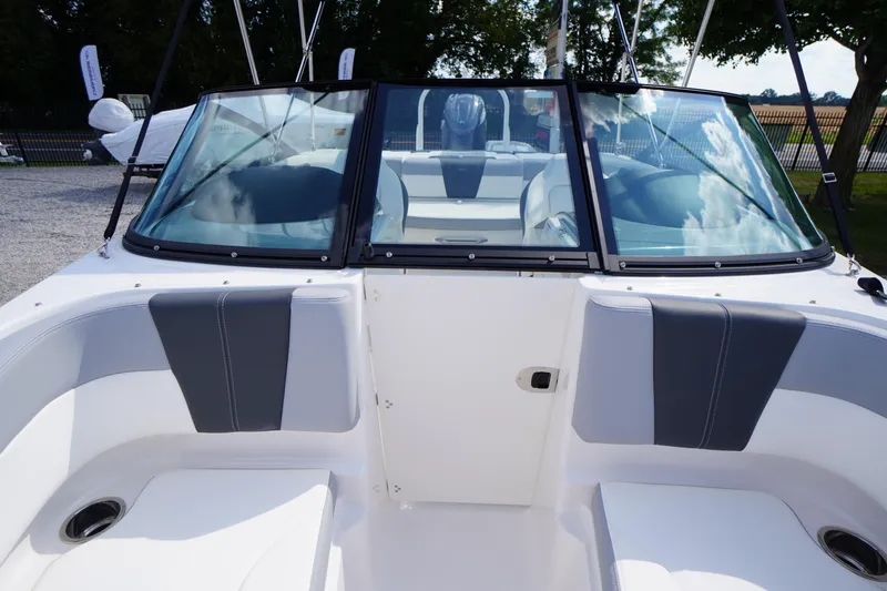 Slide: The Image of 2026 Chaparral 21 SSi OB boat interior with sleek seating and windshield view. - 8