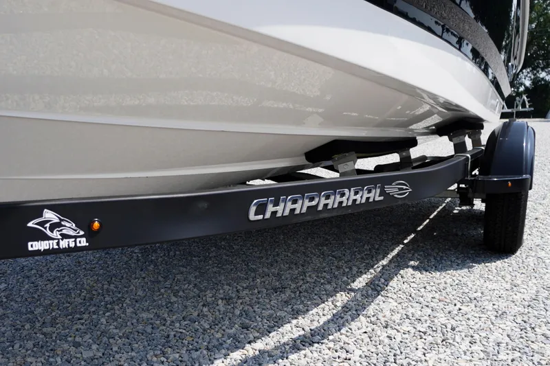 Slide: The Image of 2026 Chaparral 21 SSi OB boat on Coyote trailer, parked on gravel. - 57