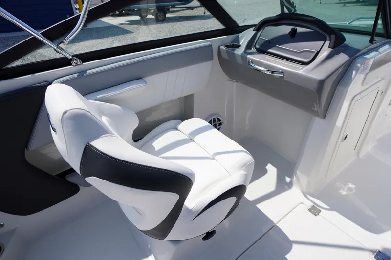 Slide: The Image of Interior of 2026 Chaparral 21 SSi OB boat, featuring sleek white seating and modern dashboard. - 18