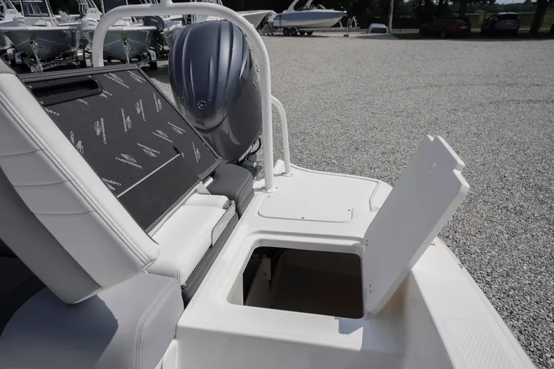 Slide: The Image of 2026 Chaparral 21 SSi OB boat with open storage compartment and visible outboard motor. - 37
