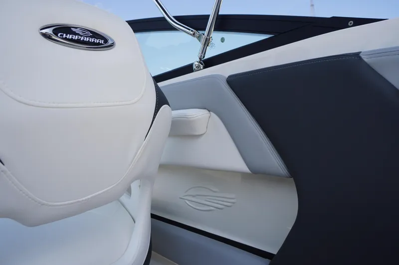 Slide: The Image of Interior of 2026 Chaparral 21 SSi OB boat, featuring sleek white and gray seating. - 23