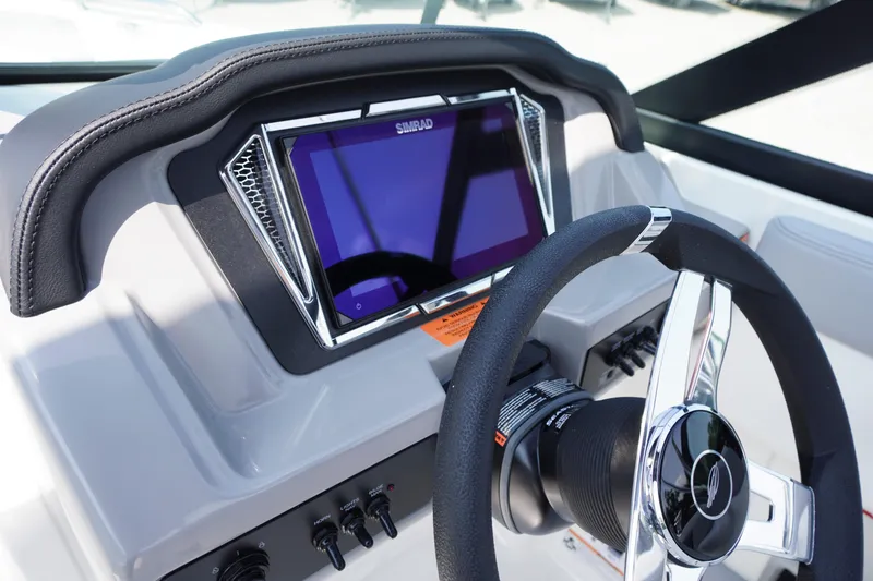 Slide: The Image of 2026 Chaparral 21 SSi OB boat dashboard with steering wheel and touchscreen display. - 15