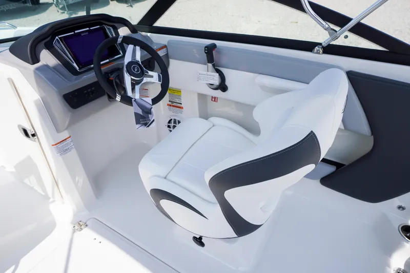 Slide: The Image of 2026 Chaparral 21 SSi OB boat cockpit with modern steering wheel and comfortable seating. - 13