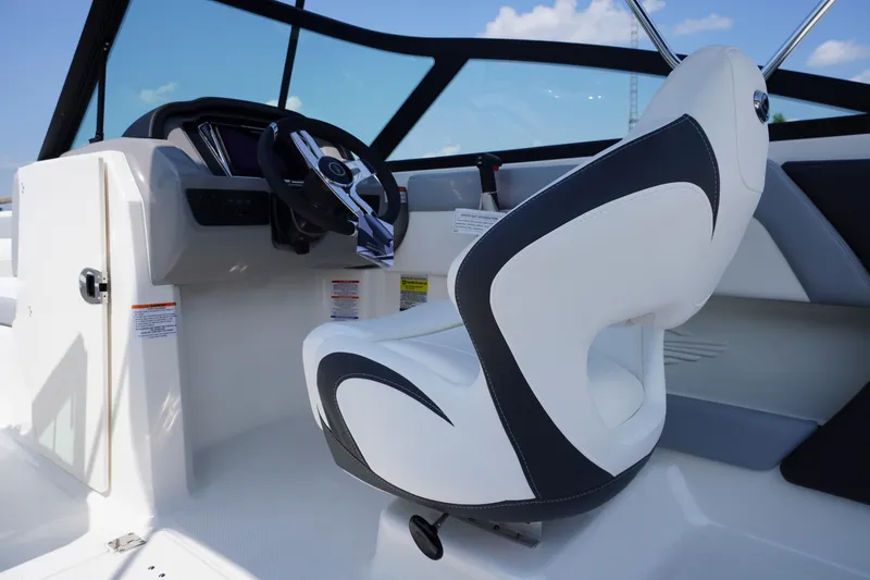 Slide: The Image of Interior view of 2026 Chaparral 21 SSi OB boat, featuring sleek steering and modern seating. - 12