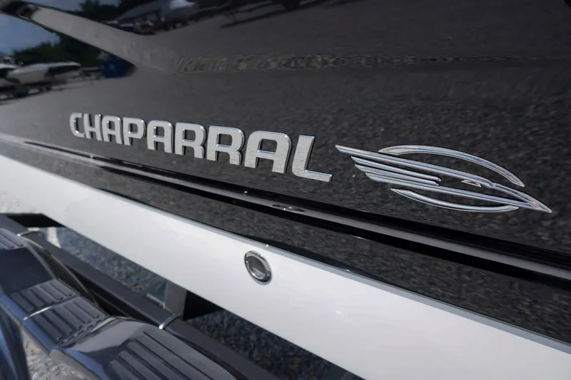 Slide: The Image of 2026 Chaparral 21 SSi OB boat logo on sleek black exterior. - 2