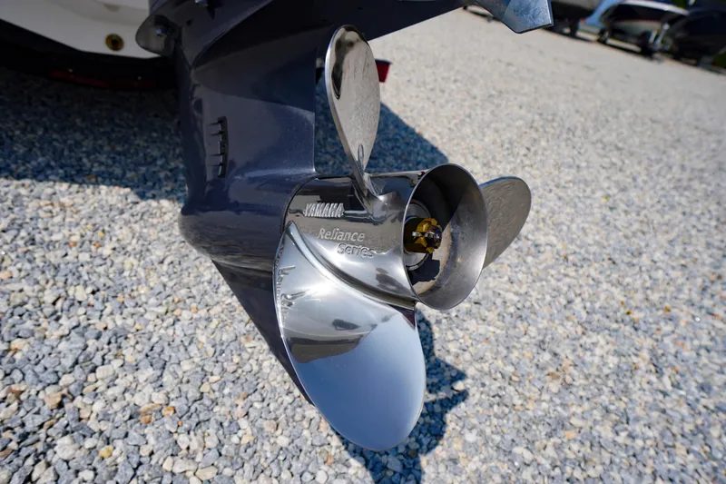 Slide: The Image of 2026 Chaparral 21 SSi OB boat propeller on gravel surface. - 55