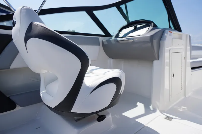 Slide: The Image of Interior of 2026 Chaparral 21 SSi OB boat, featuring sleek white and black seating. - 17