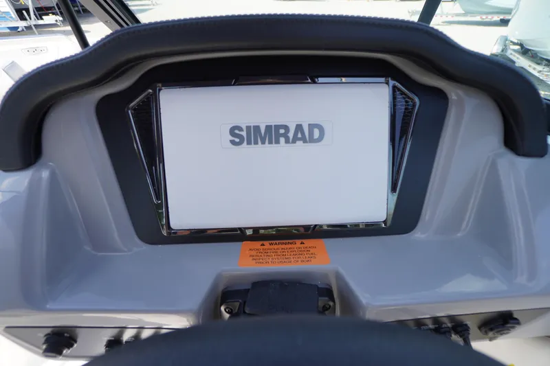 Slide: The Image of Dashboard of 2026 Chaparral 21 SSi OB featuring Simrad display. - 16