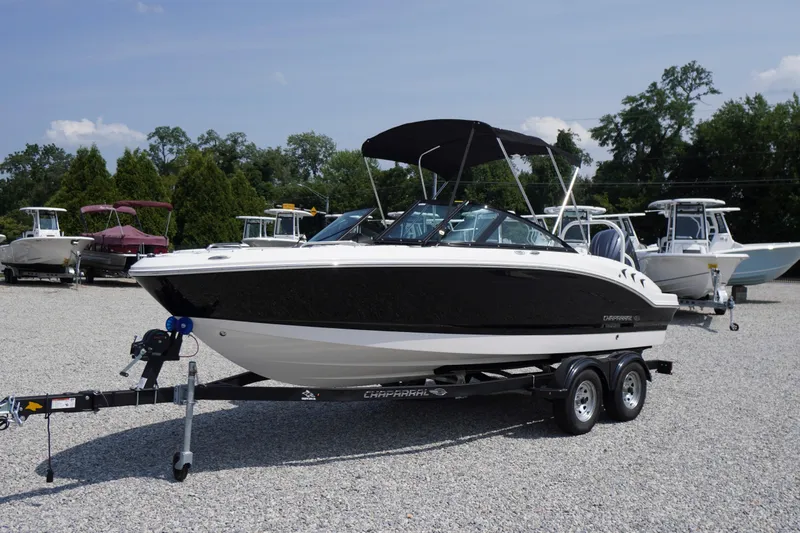 Slide: The Image of 2026 Chaparral 21 SSi OB boat on trailer, parked outdoors on gravel. - 1