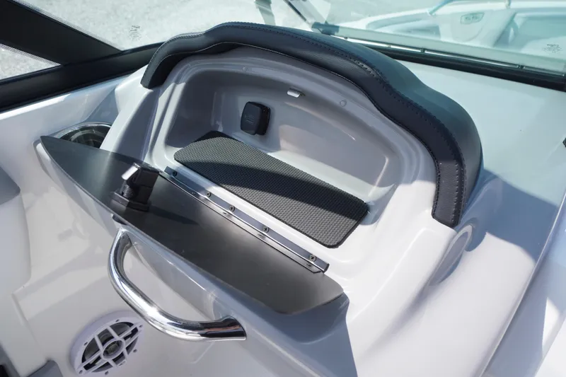Slide: The Image of 2026 Chaparral 21 SSi OB boat dashboard with storage compartment and sleek design. - 20