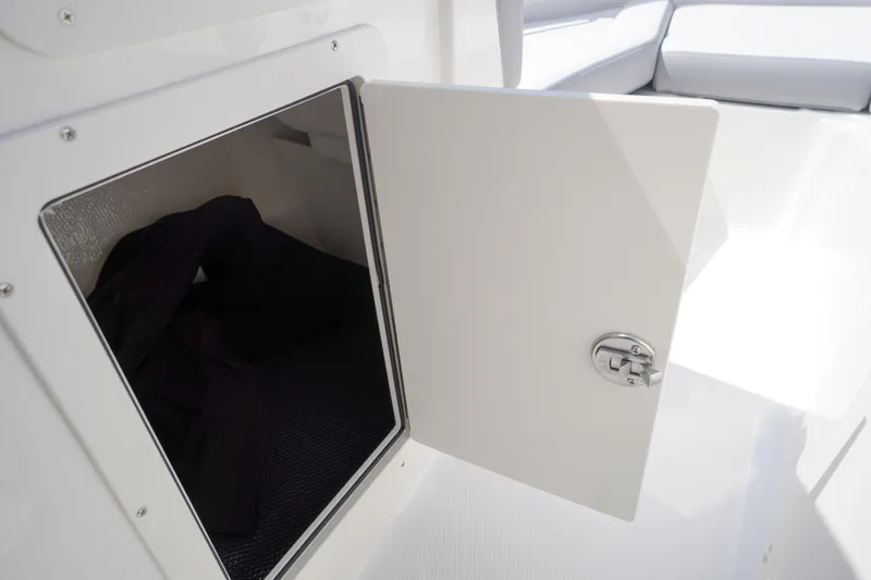 Slide: The Image of Open storage compartment on 2026 Chaparral 21 SSi OB boat, showcasing interior space. - 28