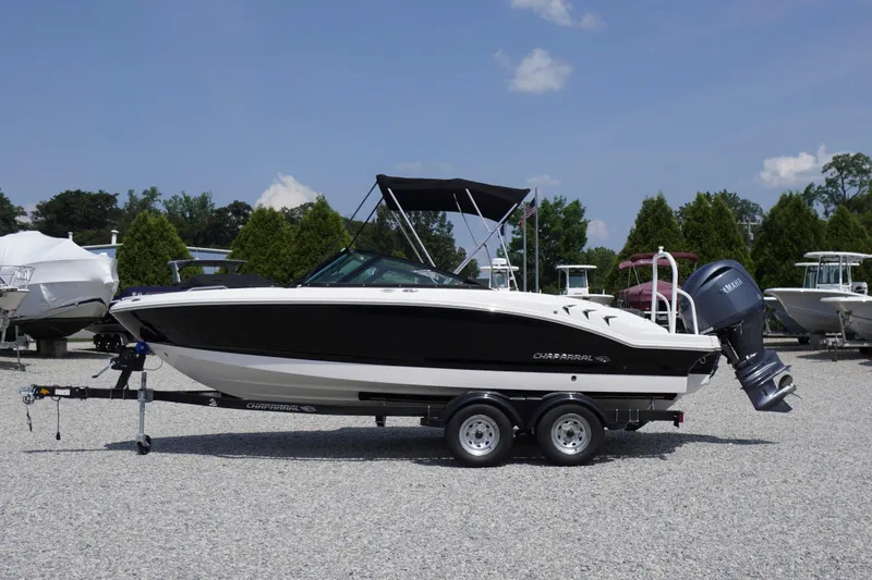 The Image of 2026 Chaparral 21 SSi OB boat on trailer, parked outdoors on gravel. - 0