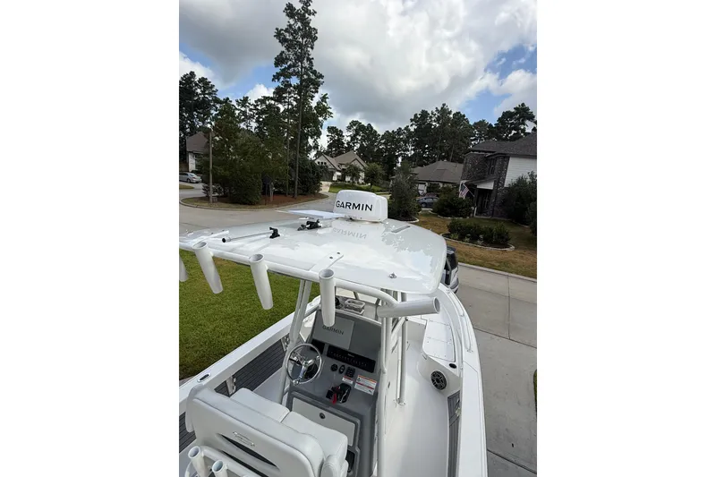 Slide: The Image of 2024 Pathfinder 2600 TRS boat with Garmin equipment, parked in a suburban neighborhood. - 11