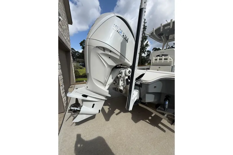 Slide: The Image of 2024 Pathfinder 2600 TRS boat with Yamaha outboard motor, parked outdoors. - 16