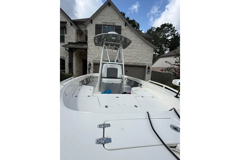 Slide: The Image of 2024 Pathfinder 2600 TRS boat parked in front of a stone house. - 5