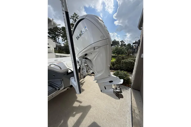 Slide: The Image of 2024 Pathfinder 2600 TRS boat with Yamaha outboard motor, parked outdoors. - 15
