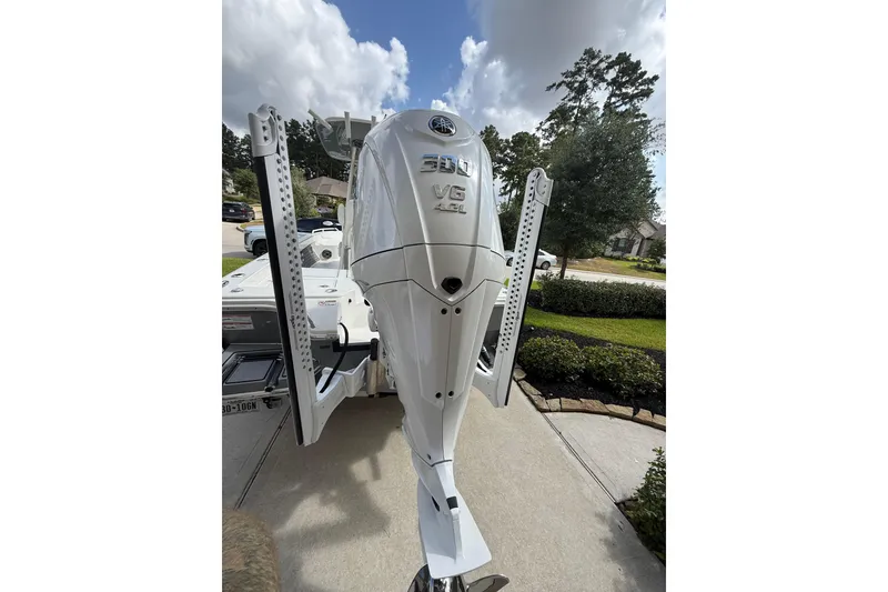 Slide: The Image of 2024 Pathfinder 2600 TRS boat with Yamaha 300 V6 engine in a driveway setting. - 14