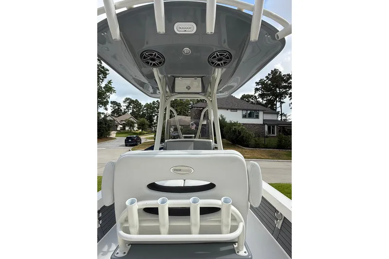 Slide: The Image of 2024 Pathfinder 2600 TRS boat interior with rod holders and overhead speakers. - 7