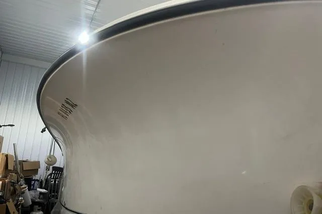 Slide: The Image of 2005 Trophy 2502 Pro boat in storage, showcasing sleek hull design. - 2