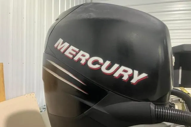 Slide: The Image of Mercury outboard motor on a 2005 Trophy 2502 Pro boat in a garage setting. - 4