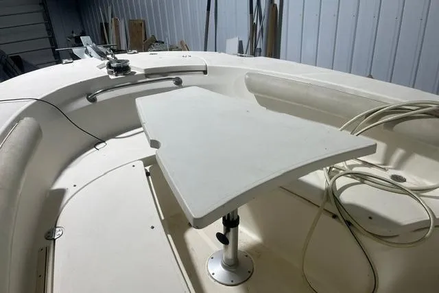 Slide: The Image of 2005 Trophy 2502 Pro boat interior with table and seating in a storage area. - 8
