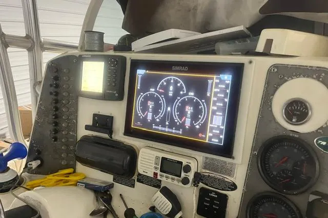 Slide: The Image of Control panel of a 2005 Trophy 2502 Pro boat with Simrad display and navigation instruments. - 13